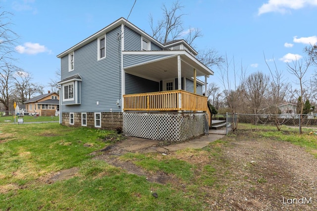2206 Woodward Ave, Kalamazoo, MI 49007 - back of property with covered porch, fence, and a yard