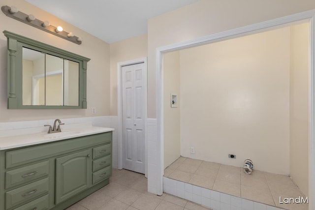 2206 Woodward Ave, Kalamazoo, MI 49007 - bathroom featuring tile patterned floors, wainscoting, tile walls, and vanity