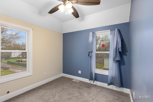 2206 Woodward Ave, Kalamazoo, MI 49007 - spare room with vaulted ceiling, carpet floors, a ceiling fan, baseboards, and visible vents
