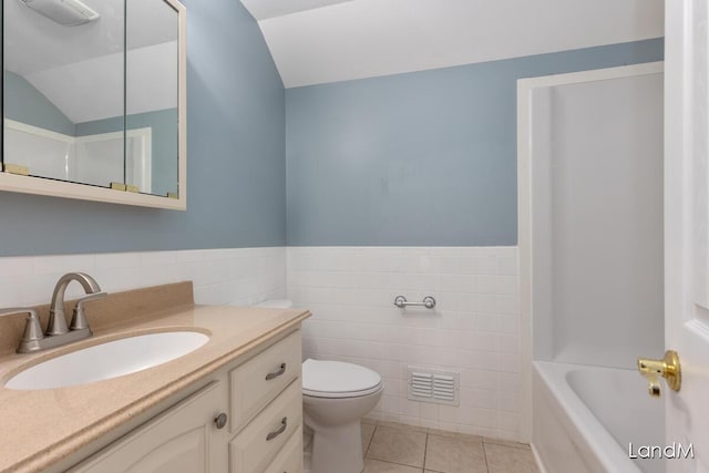 2206 Woodward Ave, Kalamazoo, MI 49007 - bathroom with tile patterned flooring, vanity, tile walls, toilet, and a washtub