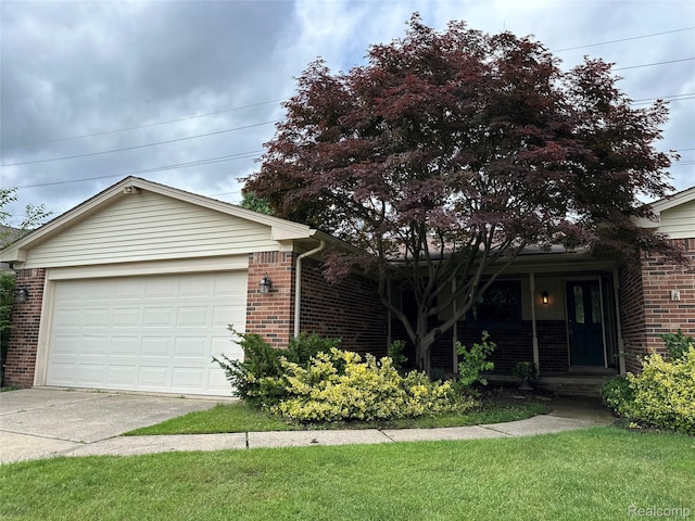 17018 White Haven Dr, Northville, MI 48168 - single story home featuring brick siding, concrete driveway, and a front yard