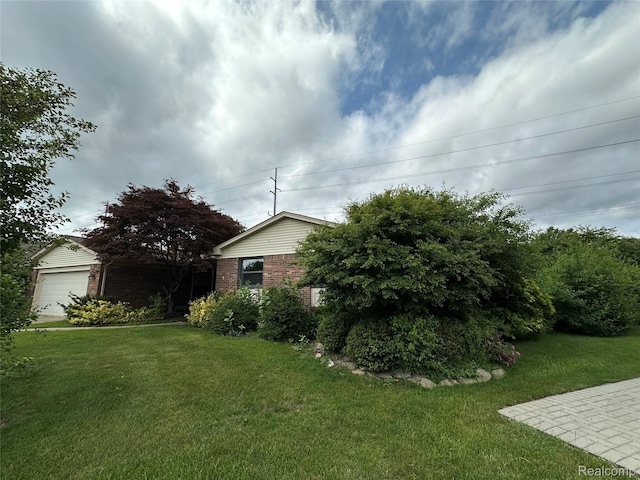 17018 White Haven Dr, Northville, MI 48168 - view of green lawn with a garage