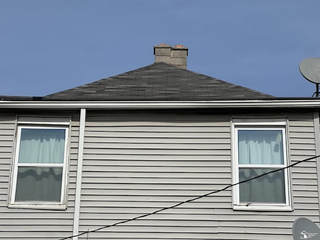 1073-1075 Morrell St, Detroit, MI 48209 - view of side of home featuring a chimney and roof with shingles