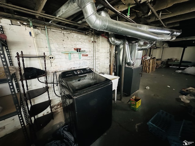 1073-1075 Morrell St, Detroit, MI 48209 - unfinished below grade area with a sink, washer / clothes dryer, concrete block wall, and heating unit