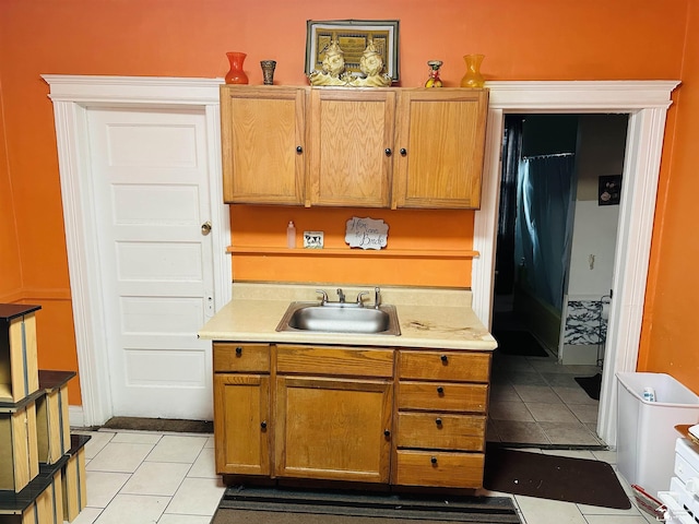 1073-1075 Morrell St, Detroit, MI 48209 - kitchen with a sink, light tile patterned floors, light countertops, and brown cabinets