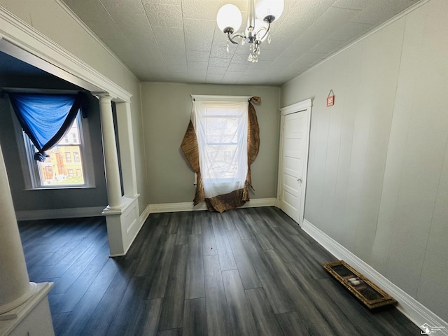 1073-1075 Morrell St, Detroit, MI 48209 - unfurnished room with decorative columns, a notable chandelier, dark wood finished floors, and baseboards