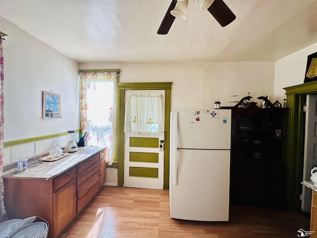 1073-1075 Morrell St, Detroit, MI 48209 - kitchen with freestanding refrigerator, light wood-style flooring, a ceiling fan, light countertops, and brown cabinets
