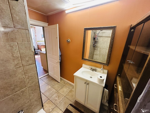 1073-1075 Morrell St, Detroit, MI 48209 - bathroom featuring baseboards, ornamental molding, a tile shower, vanity, and tile patterned floors
