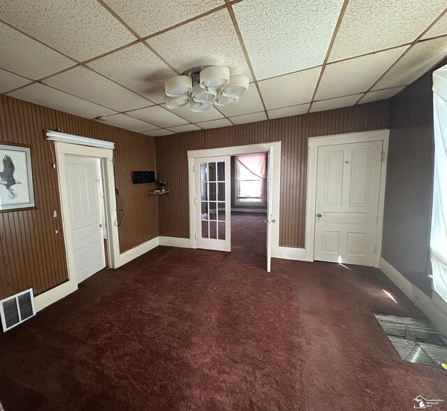 1073-1075 Morrell St, Detroit, MI 48209 - carpeted foyer entrance with wooden walls, visible vents, baseboards, and a drop ceiling