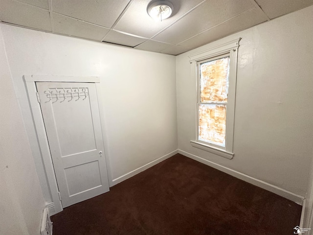 1073-1075 Morrell St, Detroit, MI 48209 - empty room featuring dark colored carpet, baseboards, a paneled ceiling, and visible vents