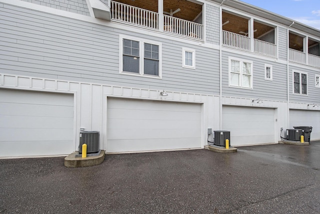 exterior space featuring central AC and an attached garage