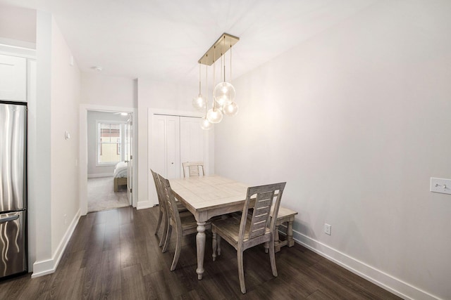 dining space featuring baseboards and dark wood-style flooring