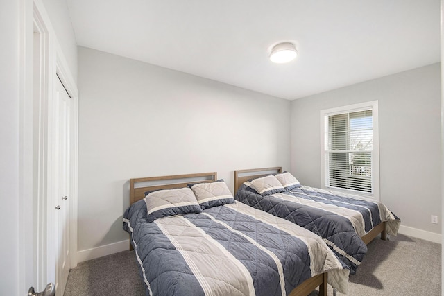 bedroom featuring baseboards and carpet floors
