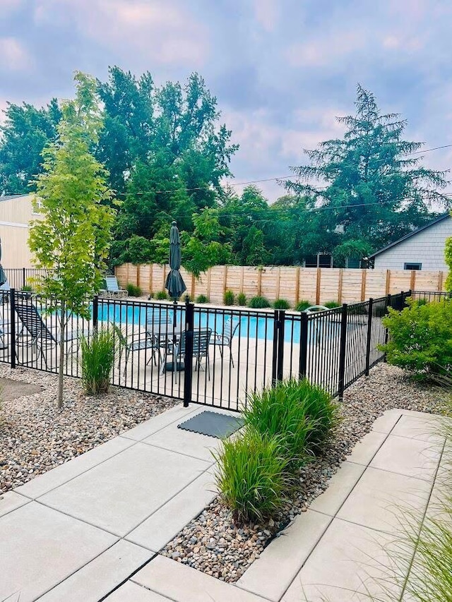 view of swimming pool featuring fence and a fenced in pool