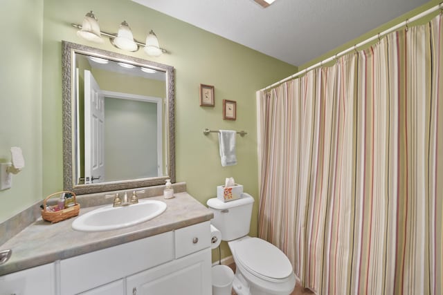 full bathroom with toilet and vanity