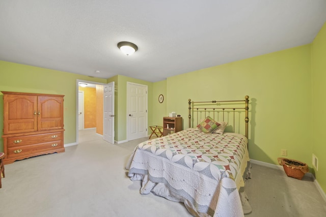 bedroom with baseboards and light colored carpet