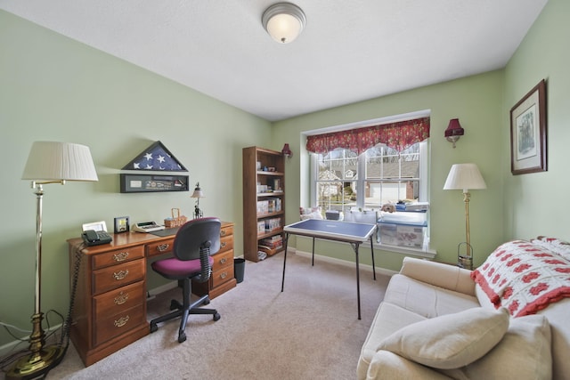 carpeted home office with baseboards