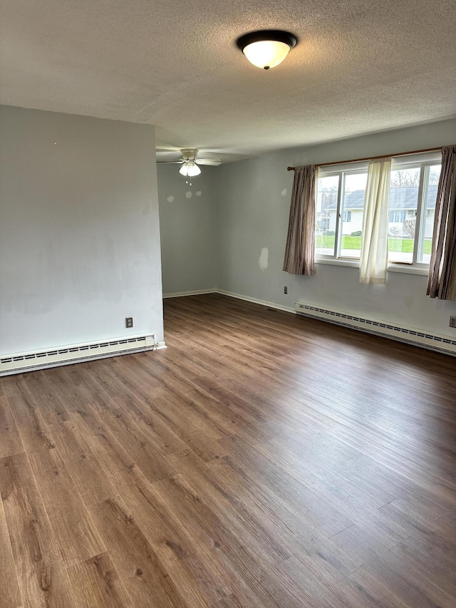 empty room featuring baseboard heating, a textured ceiling, a ceiling fan, a baseboard radiator, and wood finished floors