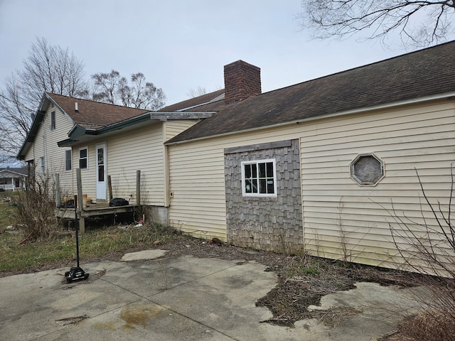 4950 Cottrell Rd, Vassar, MI 48768 - back of house with a patio, a chimney, and a shingled roof