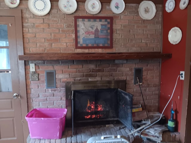 4950 Cottrell Rd, Vassar, MI 48768 - room details with a brick fireplace and visible vents