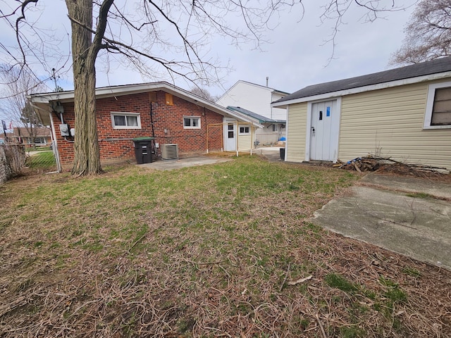 20709 Lockwood St, Taylor, MI 48180 - rear view of property with central AC unit, a patio area, fence, a yard, and brick siding