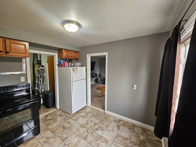 20709 Lockwood St, Taylor, MI 48180 - kitchen with brown cabinets, baseboards, black range with electric stovetop, and freestanding refrigerator