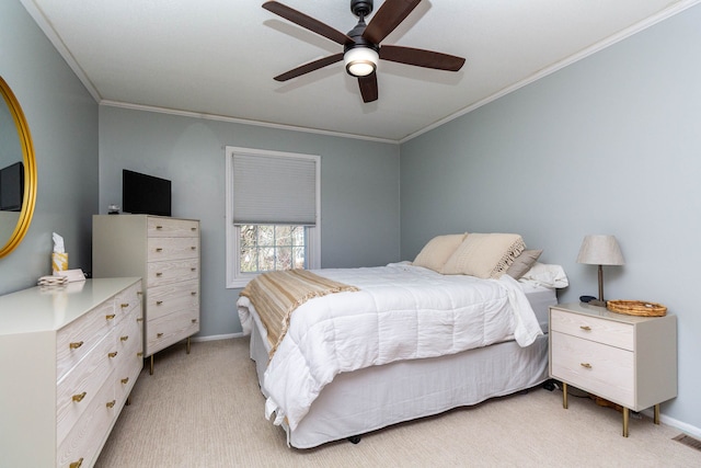 bedroom with light carpet, ceiling fan, crown molding, and baseboards