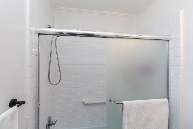 full bathroom featuring bath / shower combo with glass door and crown molding
