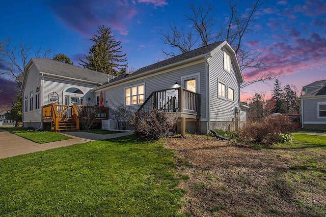 view of front facade featuring a wooden deck and a front lawn