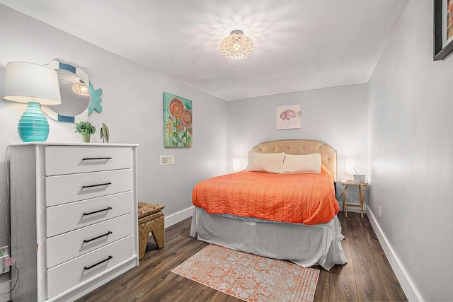 bedroom featuring dark wood-style flooring and baseboards