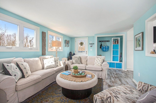 living area featuring baseboards and wood finished floors