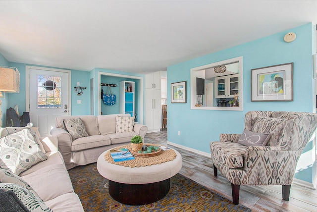 living room with baseboards and wood finished floors
