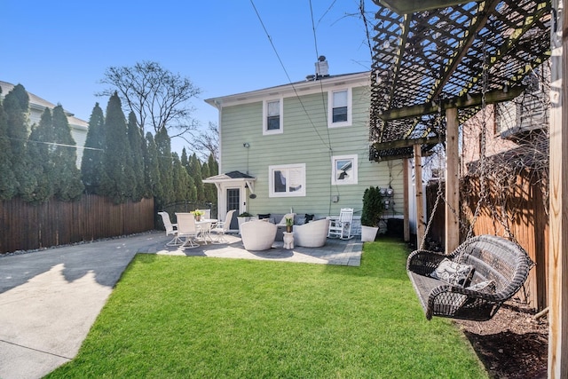 rear view of house with an outdoor living space, a yard, a fenced backyard, and a patio area