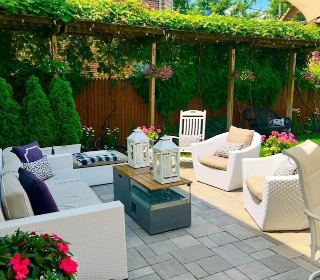 view of patio featuring an outdoor living space and fence