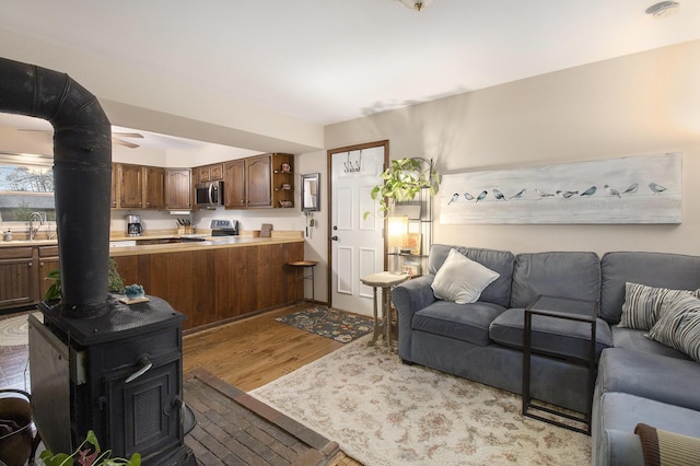 living area featuring wood finished floors and a wood stove