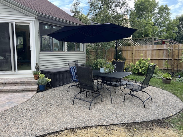 view of patio / terrace with outdoor dining space and fence