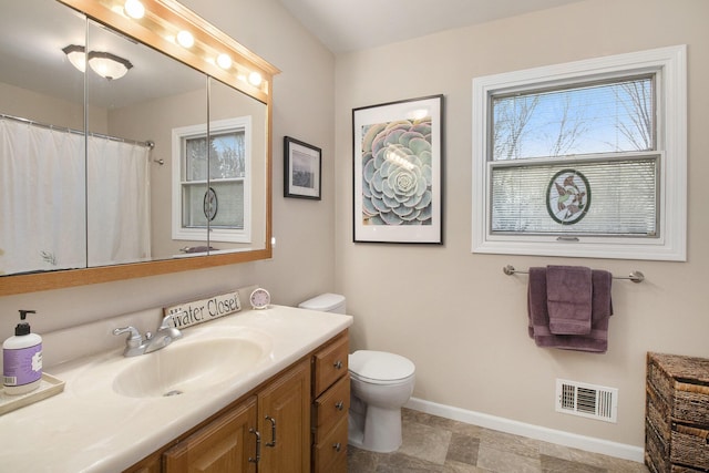 bathroom featuring visible vents, a shower with shower curtain, baseboards, toilet, and vanity