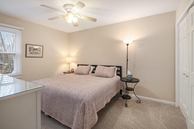 bedroom featuring baseboards, carpet flooring, and a ceiling fan
