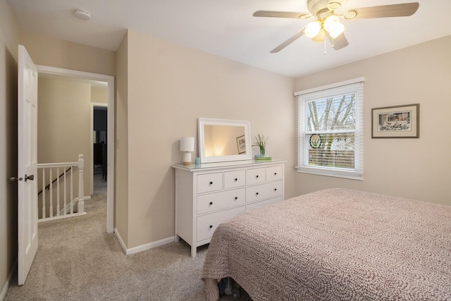 carpeted bedroom featuring a ceiling fan and baseboards