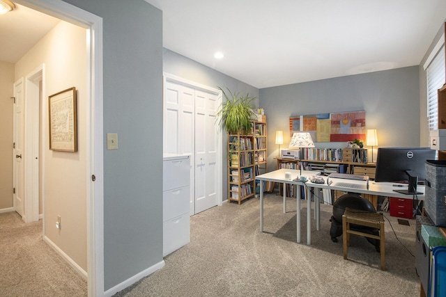 carpeted home office with baseboards