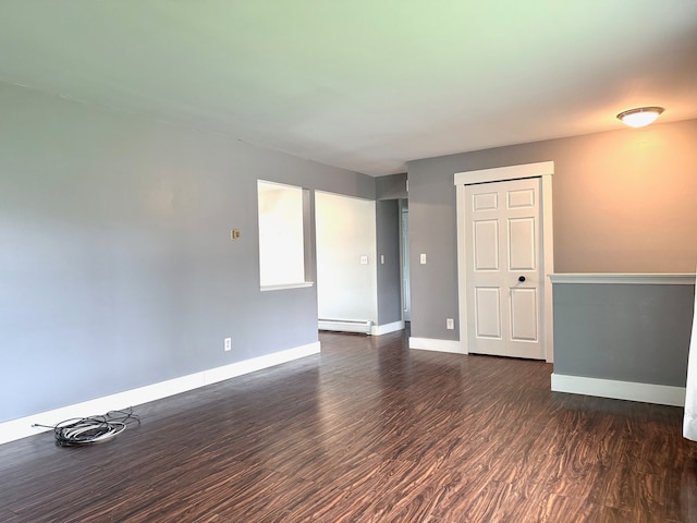 8100 Russell St, Shelby Twp, MI 48317 - empty room with dark wood-style flooring, baseboards, and baseboard heating