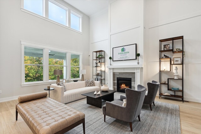 50272 Hedgewood Dr, Canton, MI 48187 - living room with a fireplace, baseboards, a high ceiling, and light wood finished floors