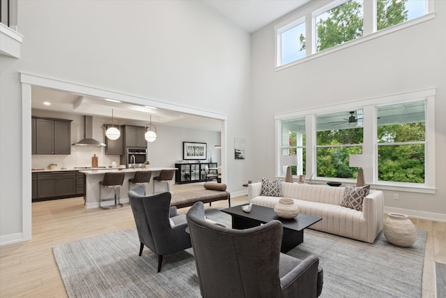 50272 Hedgewood Dr, Canton, MI 48187 - living area featuring baseboards, a high ceiling, and light wood finished floors