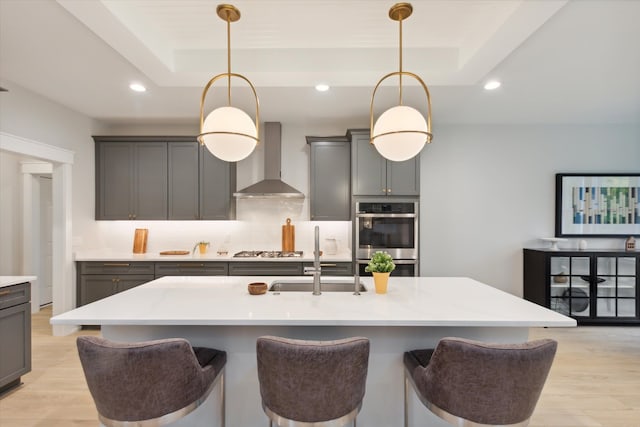 50272 Hedgewood Dr, Canton, MI 48187 - kitchen with stainless steel appliances, decorative backsplash, a raised ceiling, a sink, and wall chimney exhaust hood