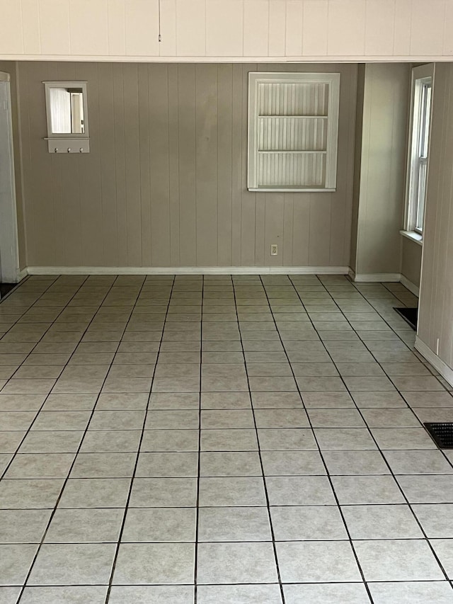 spare room with visible vents, baseboards, and light tile patterned flooring