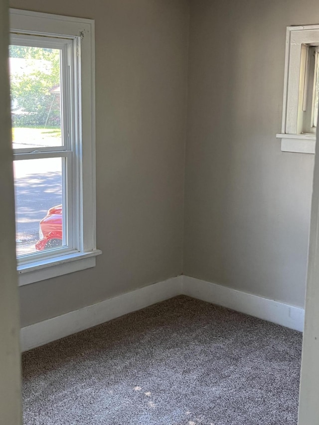 empty room with baseboards and carpet floors