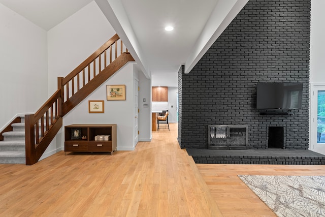 interior space featuring wood-type flooring, stairs, and baseboards