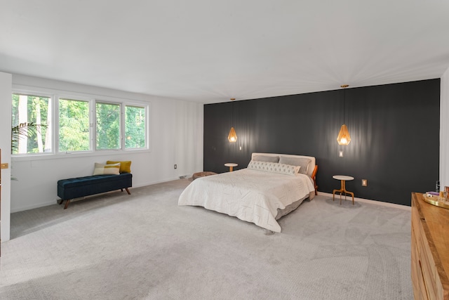 bedroom featuring baseboards and carpet