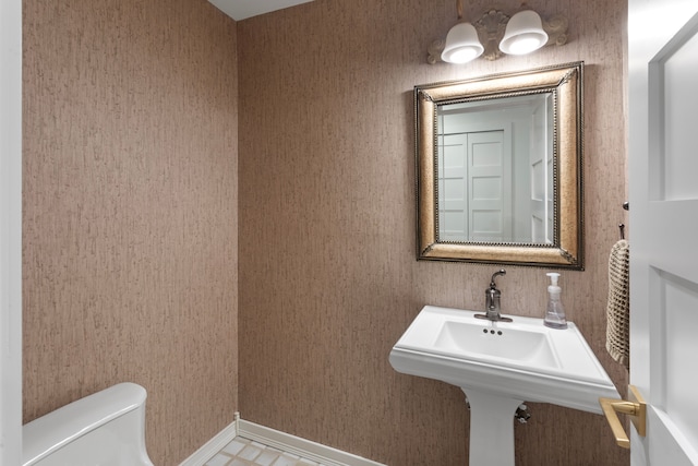 half bathroom featuring toilet and a sink
