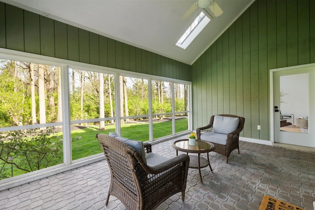sunroom featuring a ceiling fan and a skylight